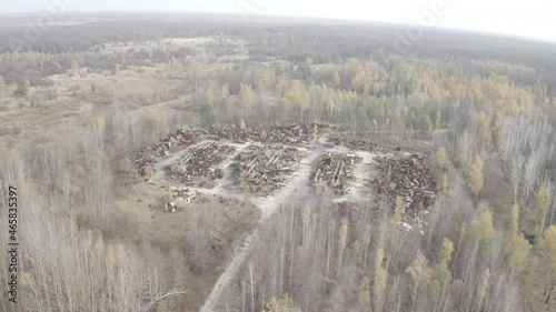 Aerial video. Old abandoned equipment that took part in the elimination of the accident. The village of Rassokha. Chernobyl. Rusty machinery.  photo