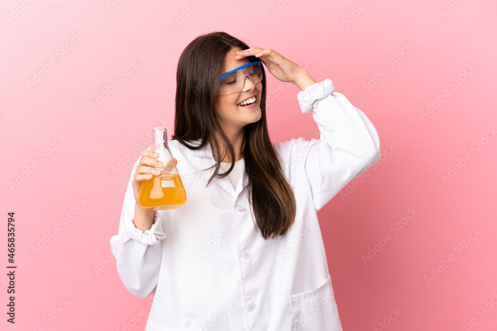 Young scientific girl over isolated pink background smiling a lot Young scientific girl over isolated pink background smiling a lot