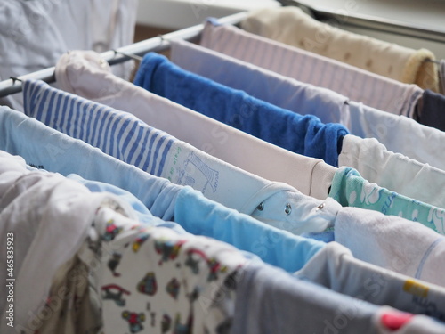 Canvas Print purely washed baby clothes for a newborn, hung on the dryer