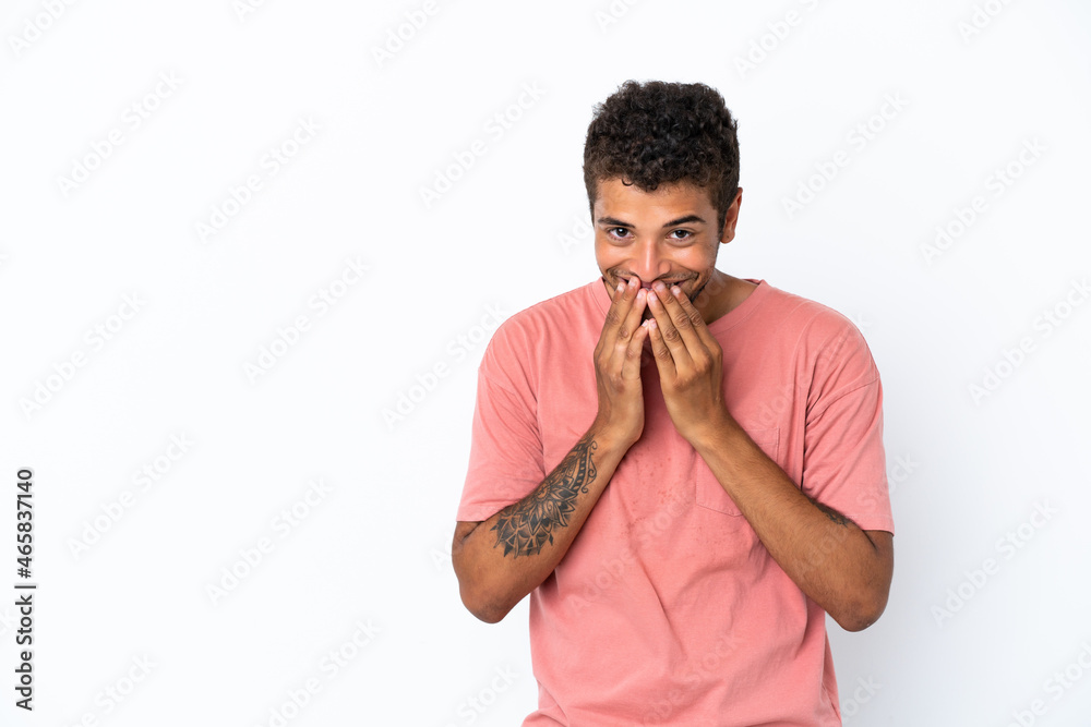 Young handsome Brazilian man isolated on white background happy and smiling covering mouth with hands Young handsome Brazilian man isolated on white background happy and smiling covering mouth with hands