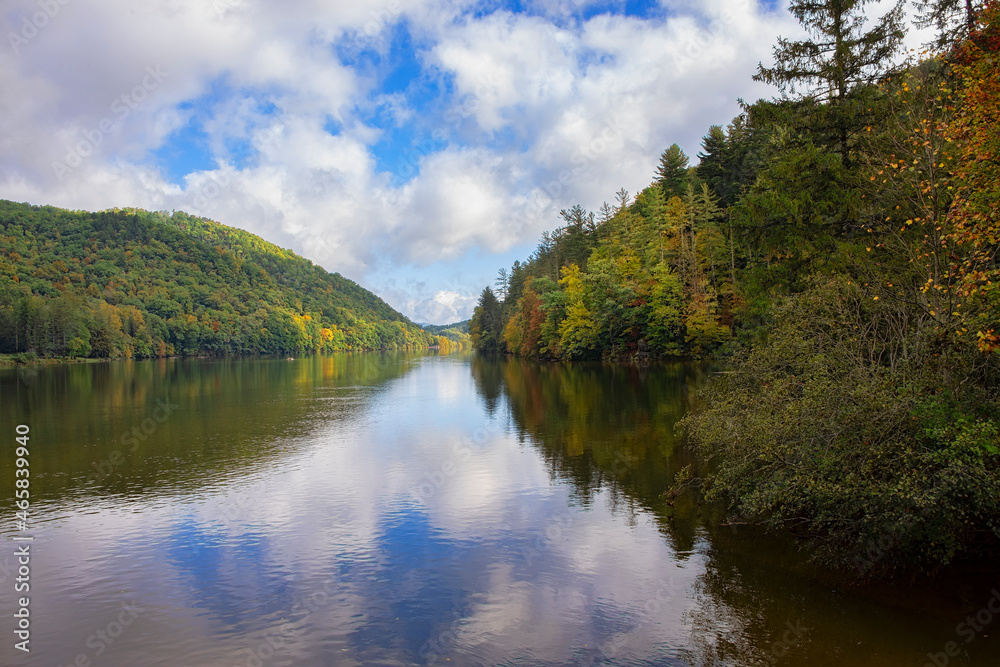 Blue Sky Over Autumn Forest on Lake Logan