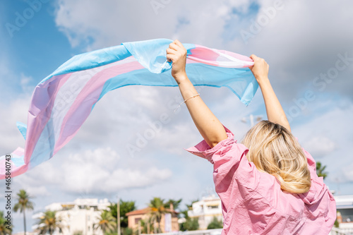 Wallpaper Mural Woman with fluttering transgender lgtbi flag on windy day Torontodigital.ca