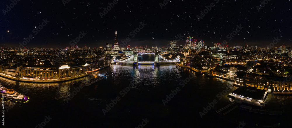 Aerial drone panorama of London Tower Bridge at Night. One of London's most famous bridges and must-see landmarks in United Kingdom