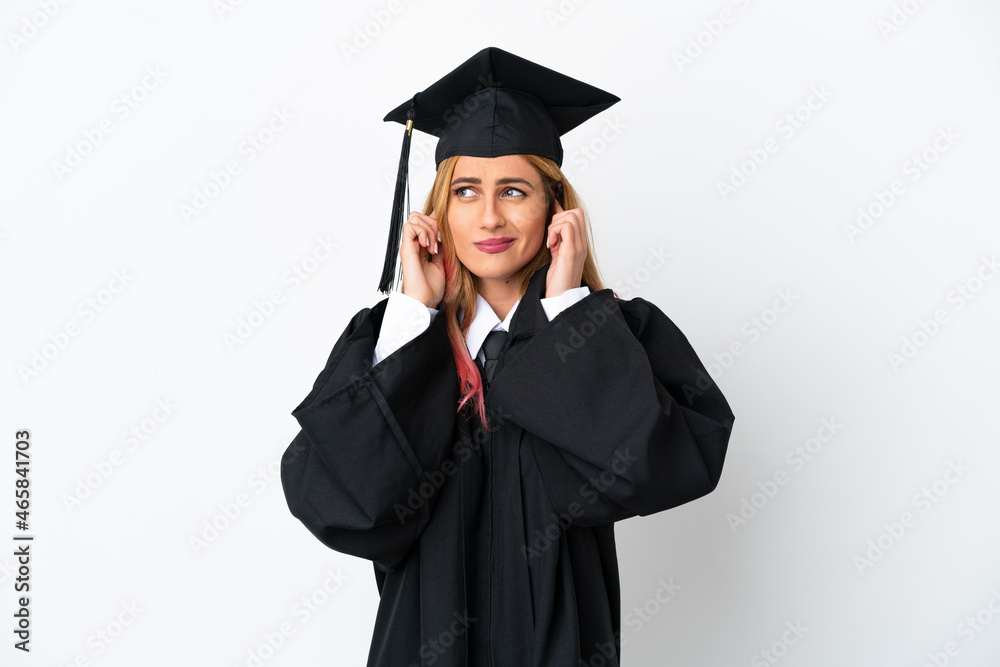 Young university graduate over isolated white background frustrated and covering ears Young university graduate over isolated white background frustrated and covering ears
