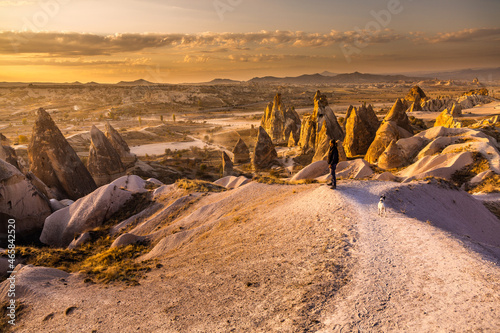 woman watching sunset in Cappadocia with peaked mountains
