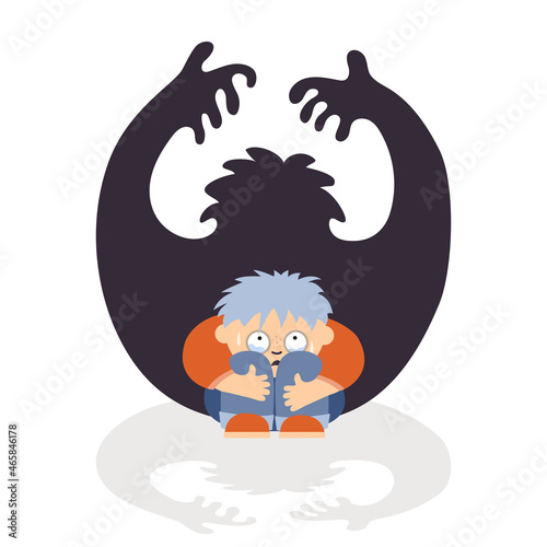 A person experiences fear. He sits huddled and afraid.