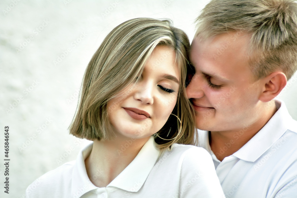 A loving guy and a girl are walking in the park. The concept of an outdoor love story. A loving guy and a girl are walking in the park. The concept of an outdoor love story.