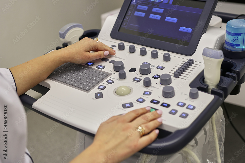The doctor works on the device of ultrasonic research. Diagnosis of human health. The doctor works on the device of ultrasonic research. Diagnosis of human health.