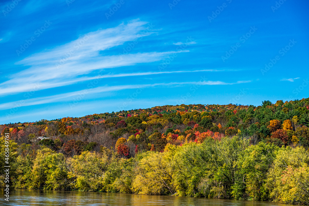 autumn landscape with mountains, river and sky