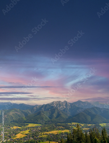 Vertical view of mountains in nature of sleeping knight tatra mountain covered with dramatic clouds aka as giewont and dramatic sunset or sunrise located in Zakopane  South Poland  Europe.