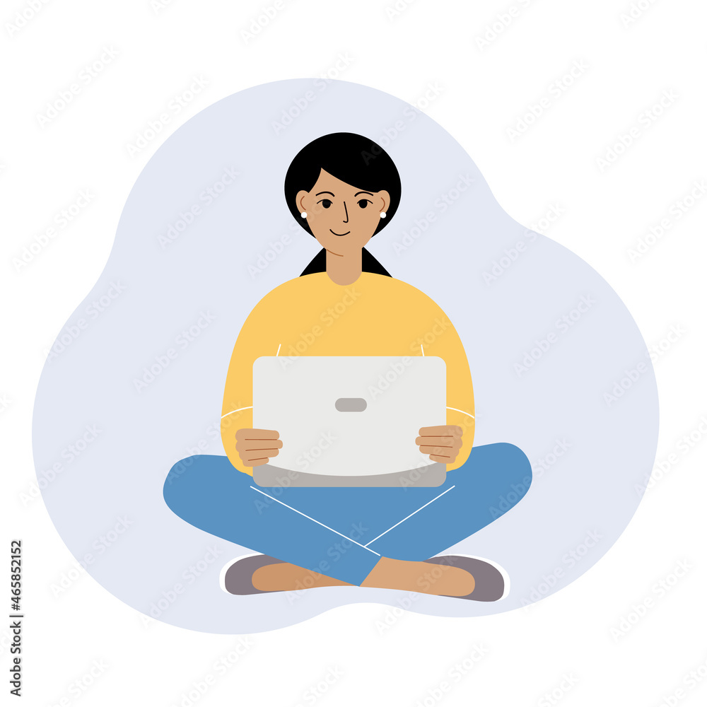 A woman or a girl sits and works at a laptop. Remote work or communication over the Internet. Satisfied, joyful.
