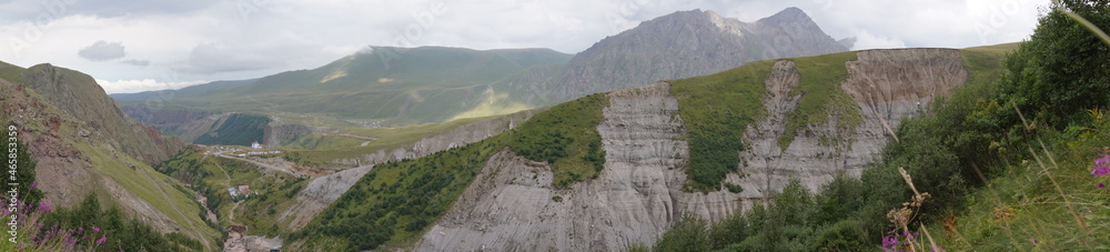 panorama of the Caucasus mountains in summer.  beautiful shadows from clouds on the ground and rocks.  picturesque plains, stones and nature