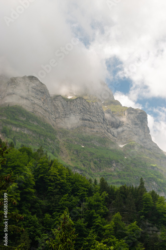 Appenzell, Switzerland, June 13, 2021 Mountain peaks in clouds and green trees