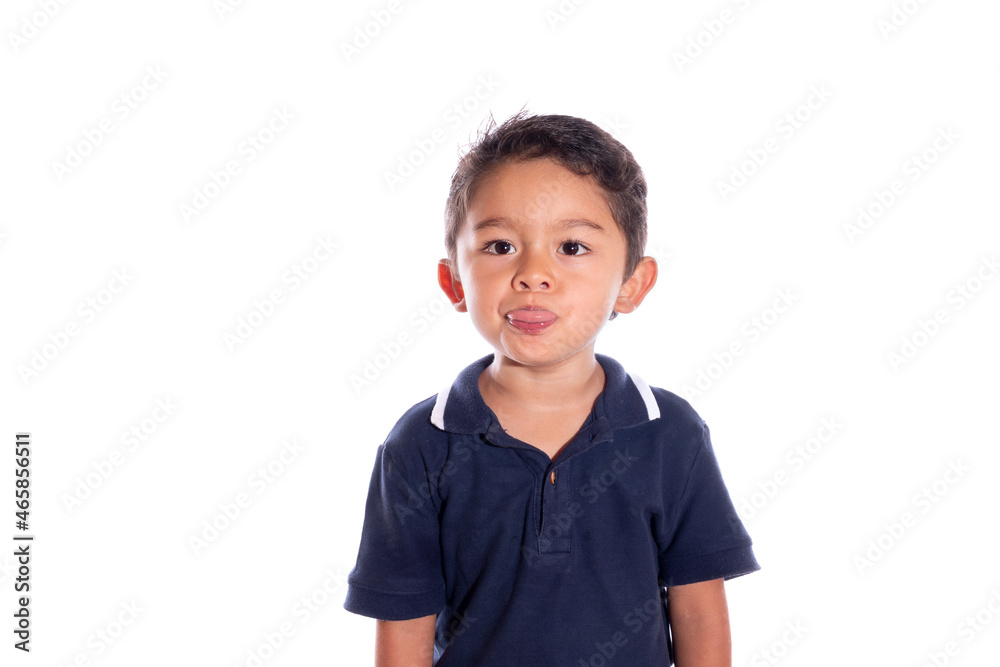 Child gesturing to camera, isolated on white background. Latin boy making faces with mouth. Child gesturing to camera, isolated on white background. Latin boy making faces with mouth.
