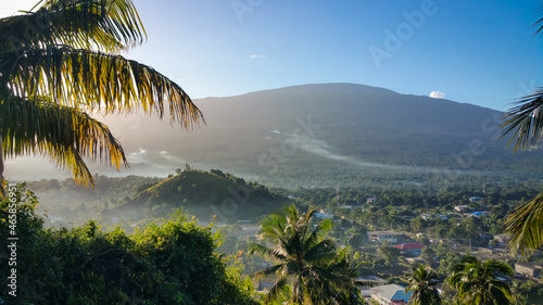 Panorama view to the palm and village on the background in Grand Comoros island during the sunrise. photo