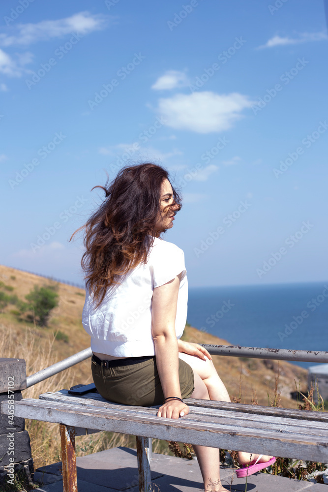 a woman siting near lake