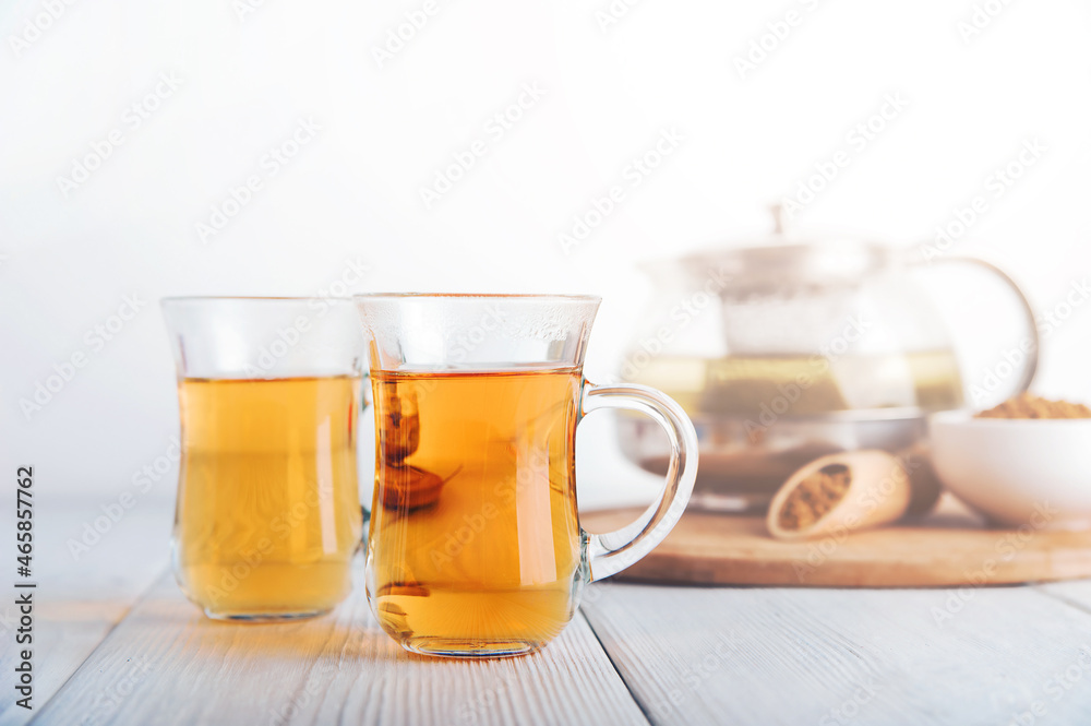 Superfood Taiwan Ku Qiao buckwheat tea in teapot and transparent cups close-up and copy space.. Superfood Taiwan Ku Qiao buckwheat tea in teapot and transparent cups close-up and copy space..