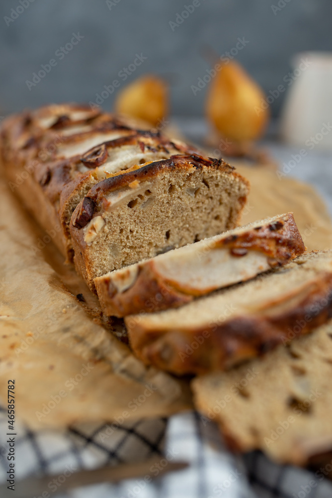 pear bread on dark grey background. wheat flour on a pear loaf cake pear bread on dark grey background. wheat flour on a pear loaf cake