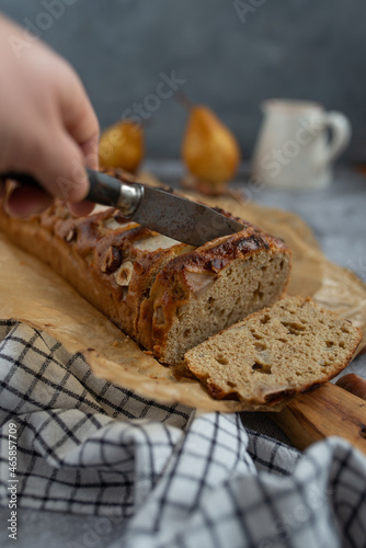 pear bread on dark grey background. wheat flour on a pear loaf cake
