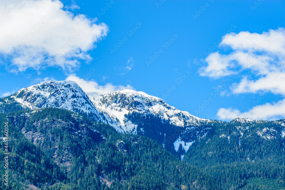 Beautiful snow in winter mountains with blue sky and white clouds. Vancouver. Canada.