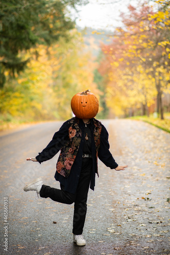 person with a pumpkin on their head dancing 