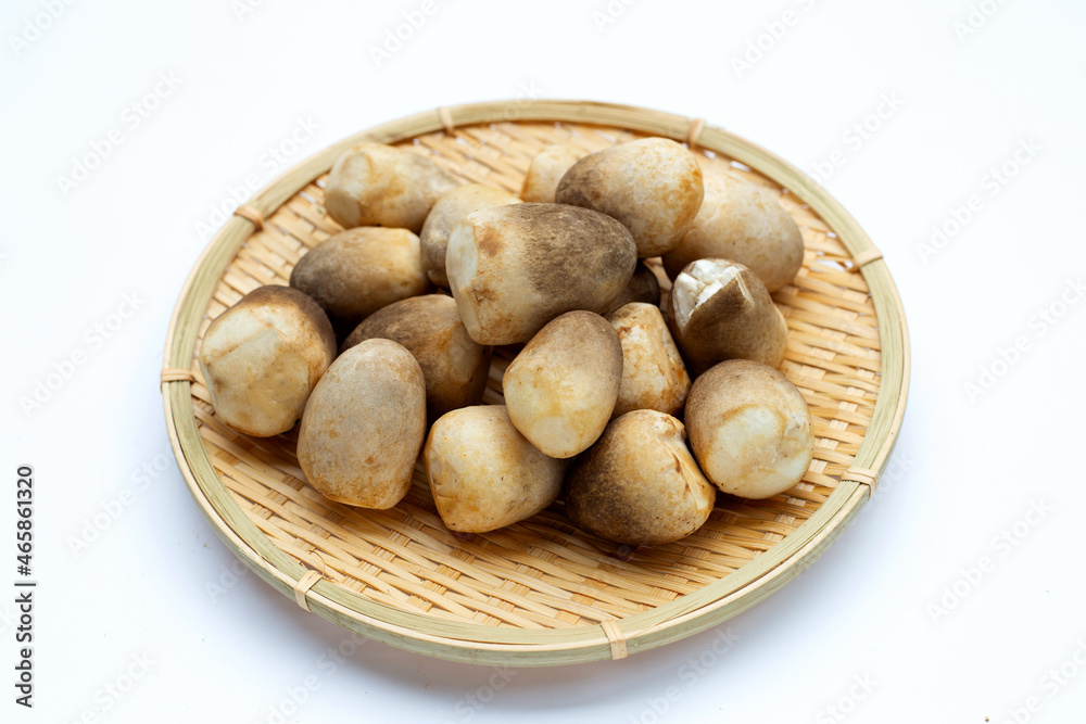 Straw mushroom in round bamboo basket on white background. Straw mushroom in round bamboo basket on white background.