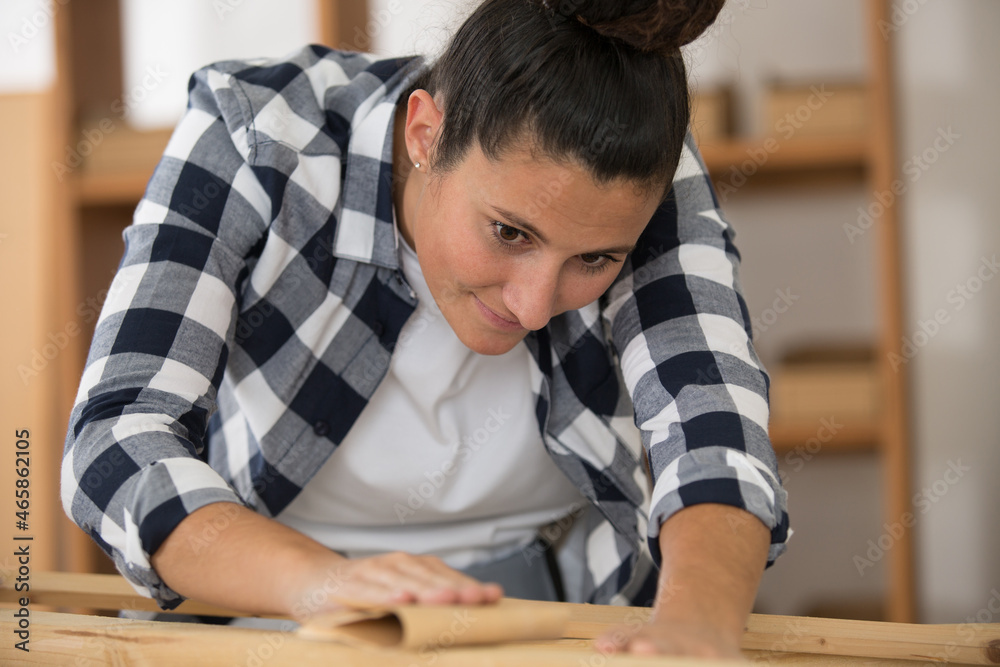woman restore wooden furniture with sandpaper woman restore wooden furniture with sandpaper
