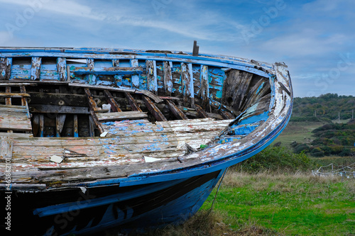  Old boat on the ground and sky background. Abandoned boat.