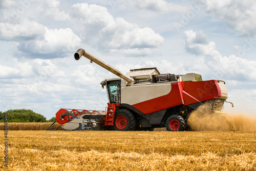 Combine harvester in action on wheat field. Harvesting is the process of gathering a ripe crop from the fields.