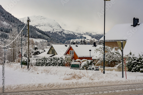 Beautiful view of snow-capped houses, mountains, and forests. Volda,  Norway photo