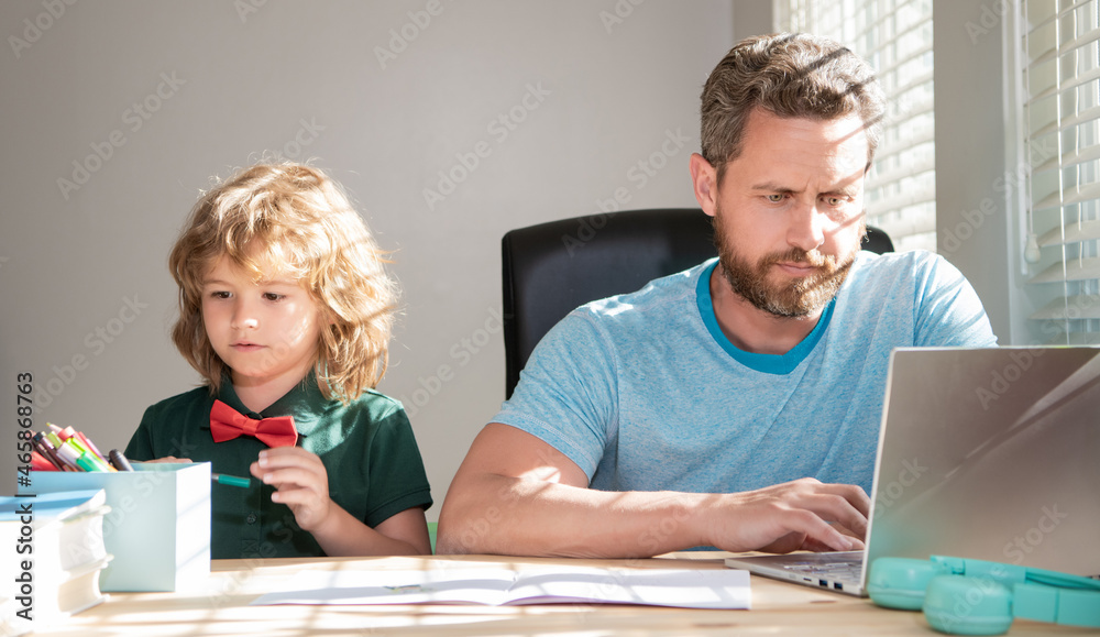 homeschooling and elearning. back to school. serious father and son use computer at home. homeschooling and elearning. back to school. serious father and son use computer at home.