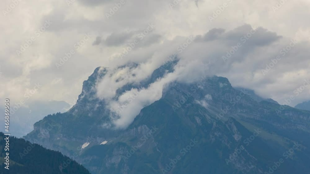 Timelapse of clouds passing mountain peak. Stormy clouds touches mountain peak. Rautispitz, Canton Glarus, Switzerland. Timelapse of clouds passing mountain peak. Stormy clouds touches mountain peak. Rautispitz, Canton Glarus, Switzerland.