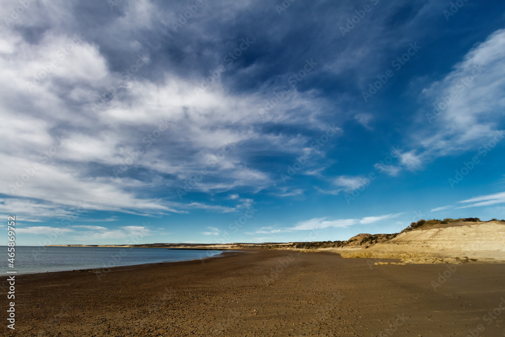 Desolate beach with small cliffs at El Pozo beach, south of Puerto Madryn, Argentina Desolate beach with small cliffs at El Pozo beach, south of Puerto Madryn, Argentina