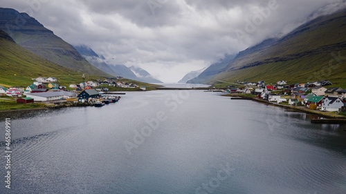 Beautiful aerial view of Faroe Islands Towns next to the ocean Canals, and boats and massive mountains. photo
