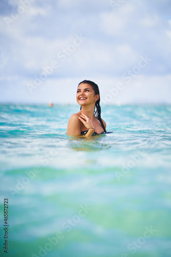 Smiling woman with wet hair in blue sea © Daniel