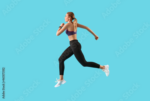 Sporty running woman on color background