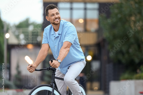 Man riding bicycle on city ...