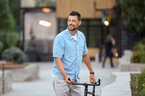 Man with bicycle on city st...