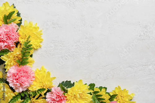 Composition with beautiful chrysanthemums and carnations on light background  closeup