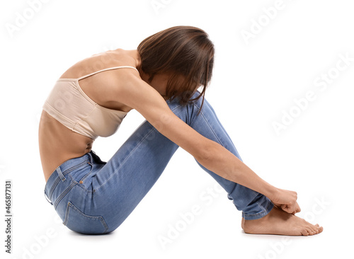 Young skinny woman on white...