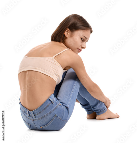 Young skinny woman on white...