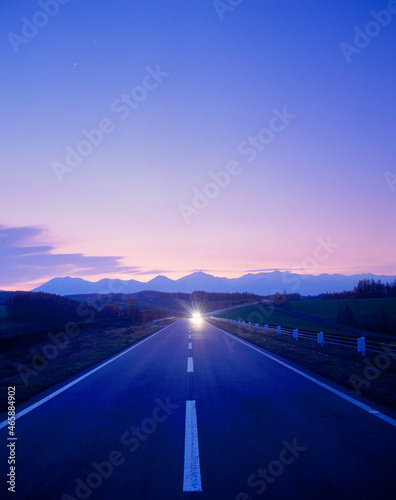 黎明の道路と十勝連峰とヘッドライトの光芒, 美瑛町,上川郡,北海道 photo