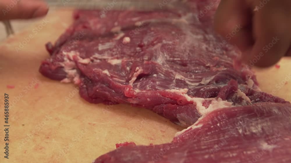 Raw meat close up cleaning and slice, can be used to represent fresh red meat, culinary cooking or omophagia Raw meat close up cleaning and slice, can be used to represent fresh red meat, culinary cooking or omophagia