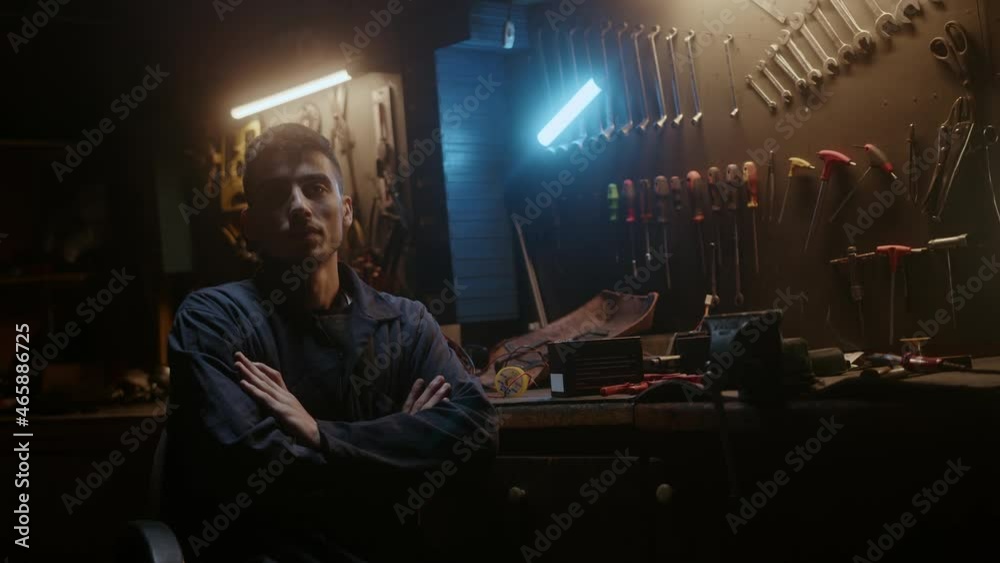 Workshop owner confident man sitting on chair, fold one's arms and looking at camera