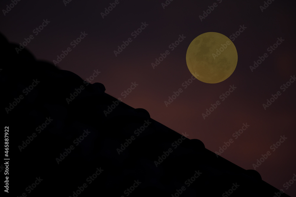 Roof silhouette with full moon in the evening. Roof silhouette with full moon in the evening.