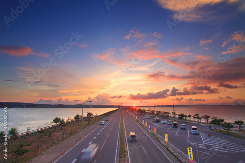 ロードパークの歩道橋上から望む本島側の海中道路と夕日, うるま市,沖縄県 photo