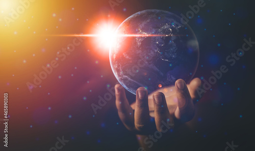Energy and ecology concept, Human hand holding flying earth, Elements of this image furnished by NASA.	