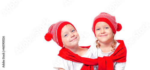 kids in christmas red caps are smiling at the camera