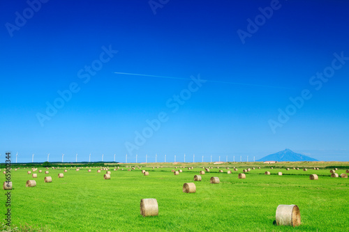 風力発電の風車と牧草ロールと利尻岳, 天塩町,天塩郡,北海道