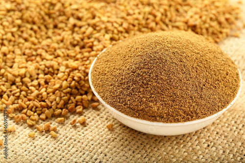 Bowl of organic fenugreek powder, Indian spices.